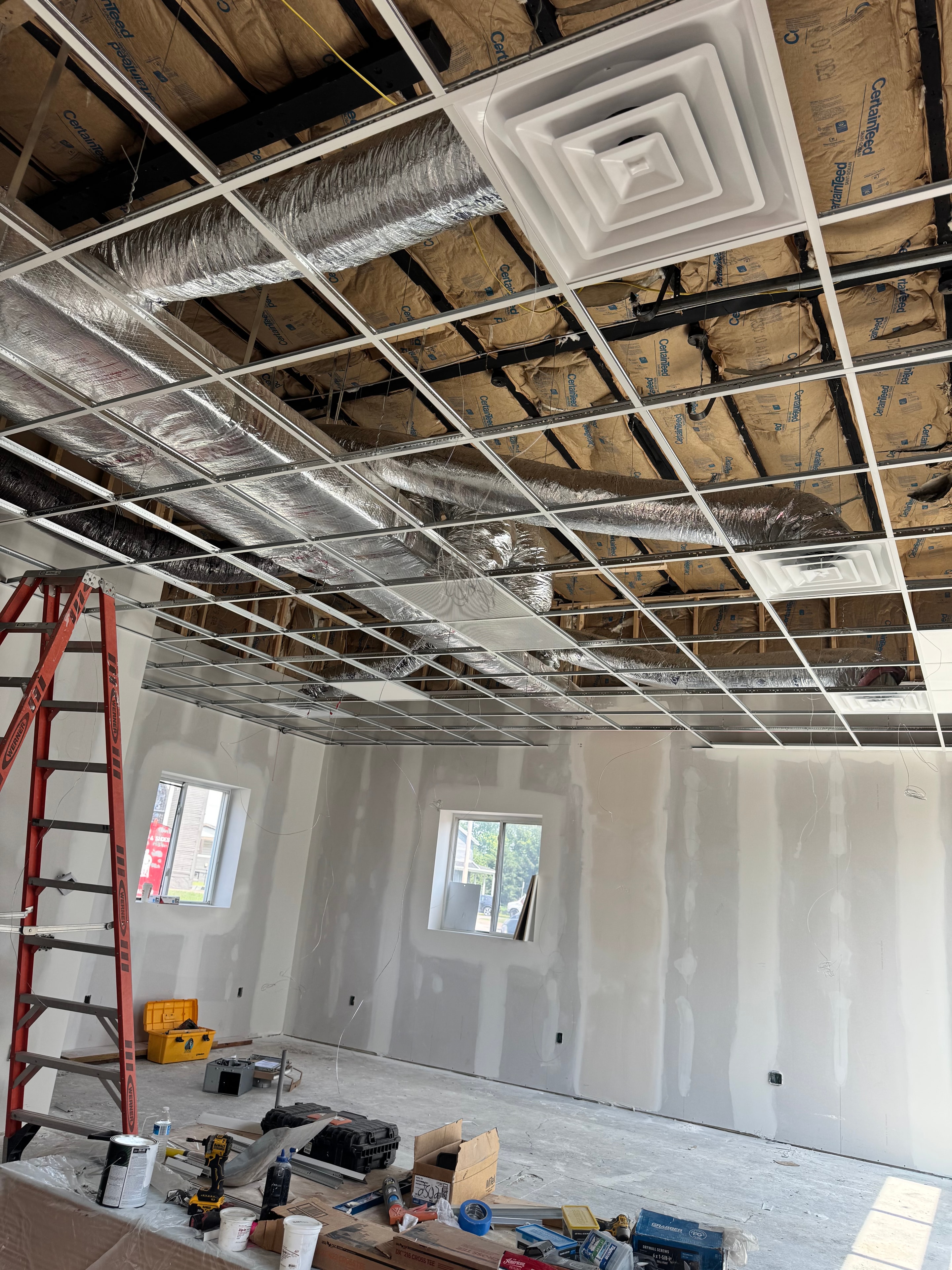 Completed commercial ceiling ductwork with flexible duct runs and diffusers installed in multi-story commercial space near Pittsburgh, PA