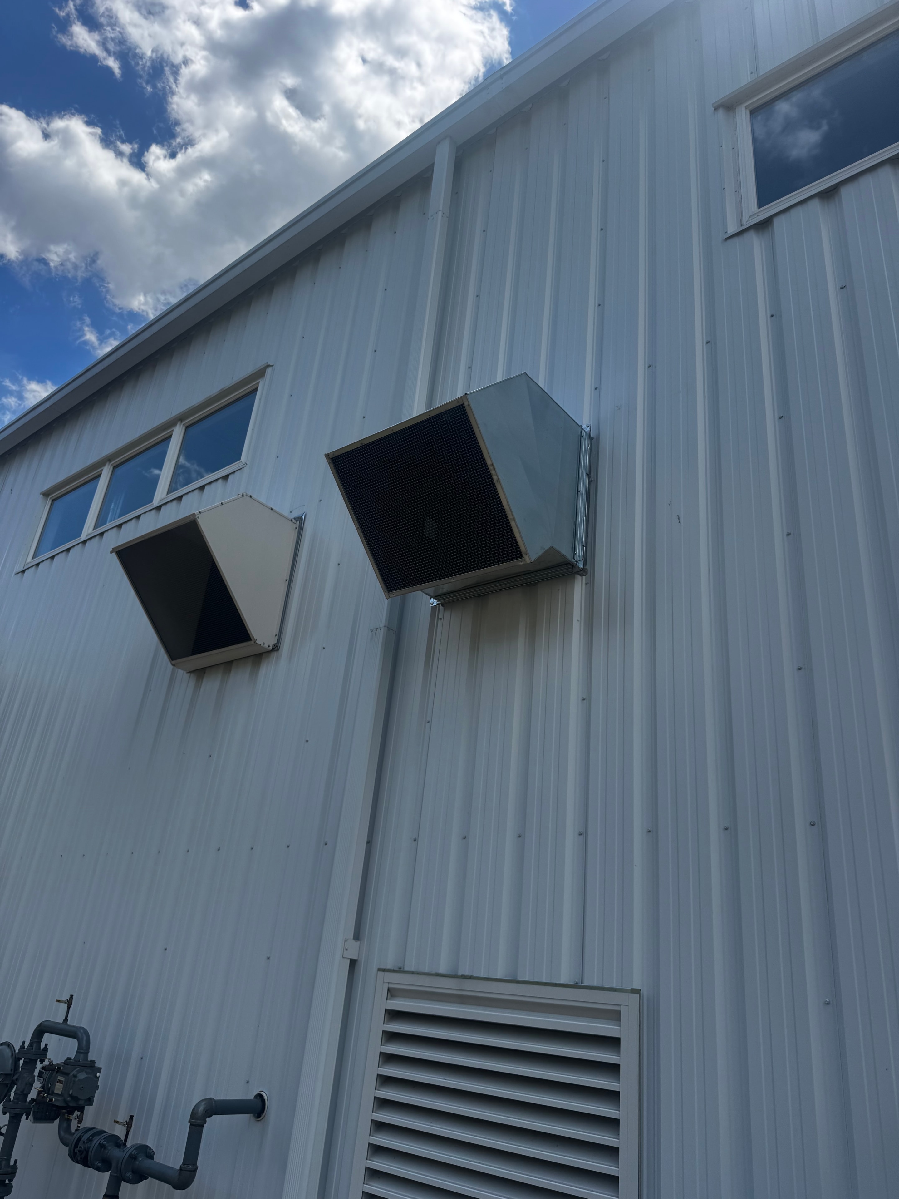 Exterior wall HVAC penetrations with custom sheet metal louver boxes installed on commercial building — Monroeville, PA