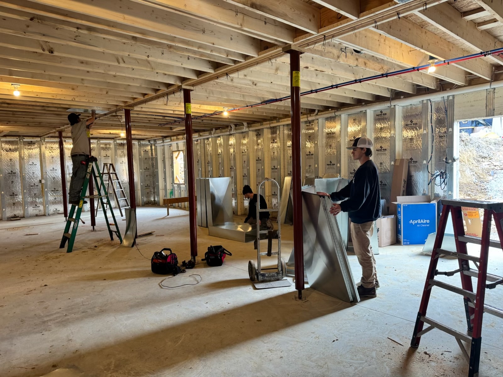 Heirloom Mechanical technicians installing ductwork and HVAC equipment in new home near Mount Pleasant, PA